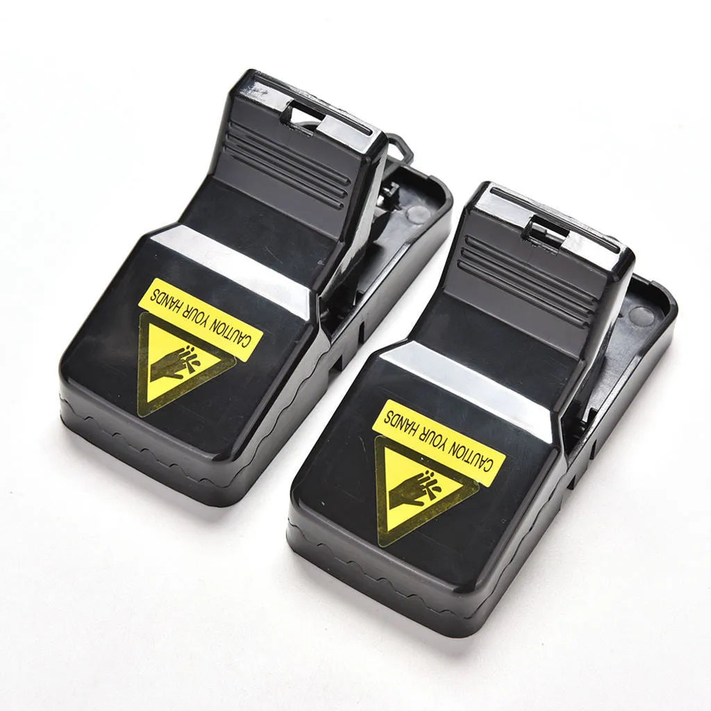 Six black snapping mousetraps with smooth plastic surface showing precise dimensions