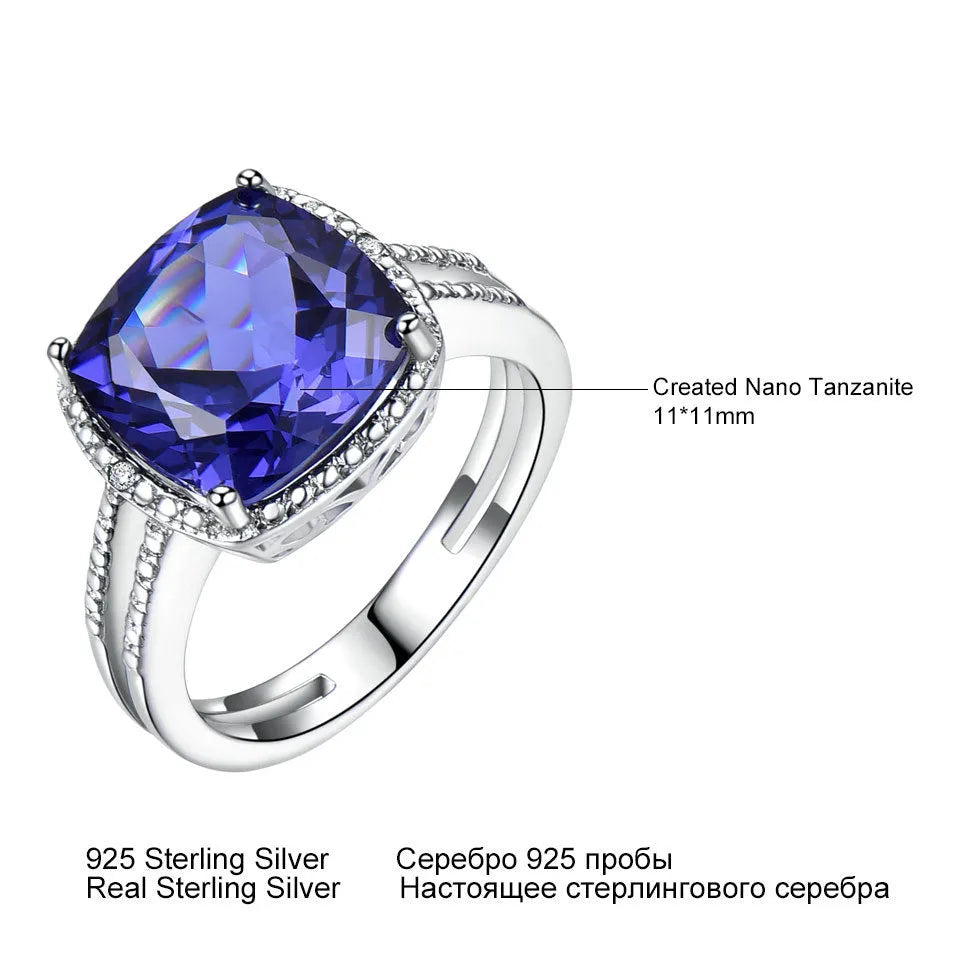 Women's sterling silver ring with a blue tanzanite gemstone on a model's hand.