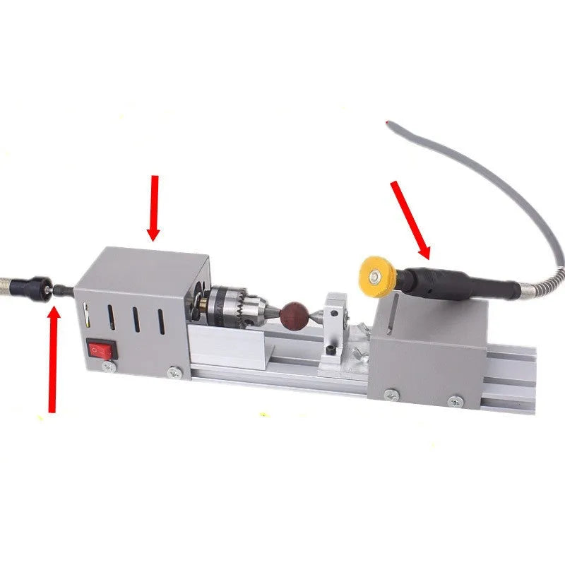 Mini metal manual woodworking lathe with carving knives on a workbench