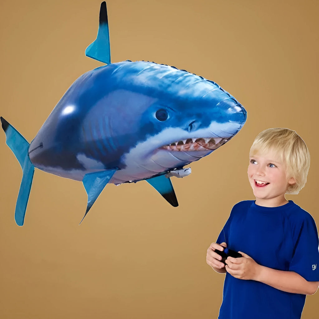 Large remote control shark inflatable balloon toy floating indoors with remote.