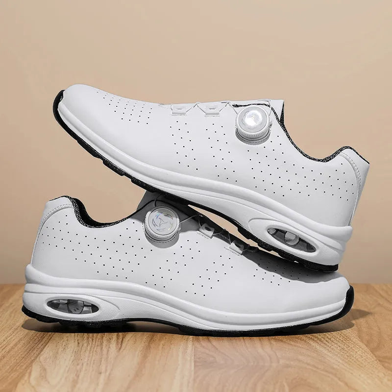 Low-top black and white mesh casual shoes with cross shoulder strap and round toe on a composite sole.