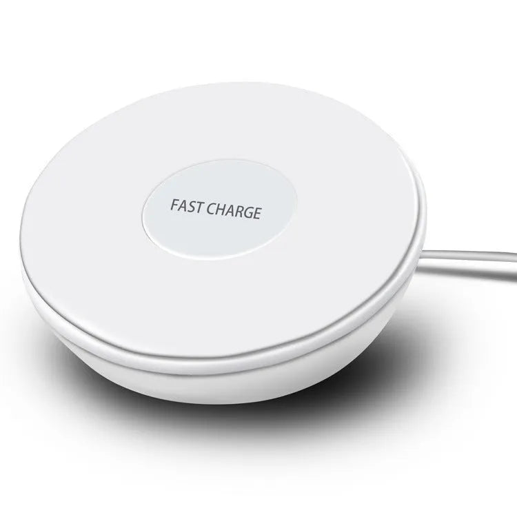 White wireless charging pad with LED digital clock display and control buttons on a desk.