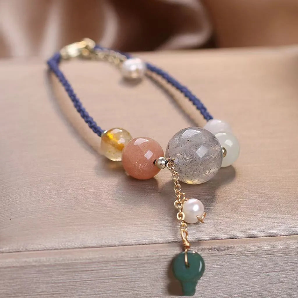 Hand-woven women's bracelet with peace buckle, crystal beads, and sequins in red, green, or blue.