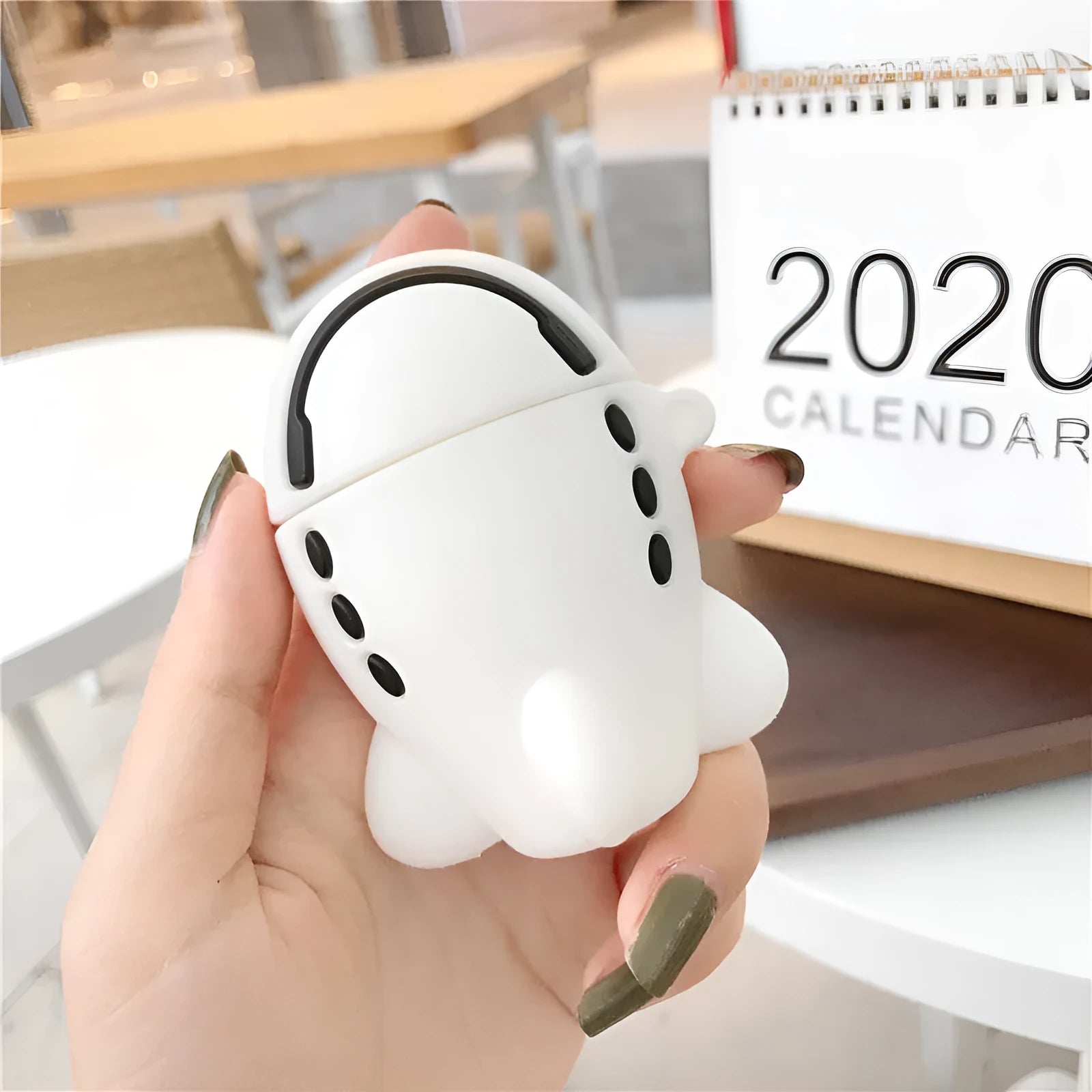 Silicone flip-cover protective case for AirPods 1 and 2 with airplane headset cartoon print and carry hook.
