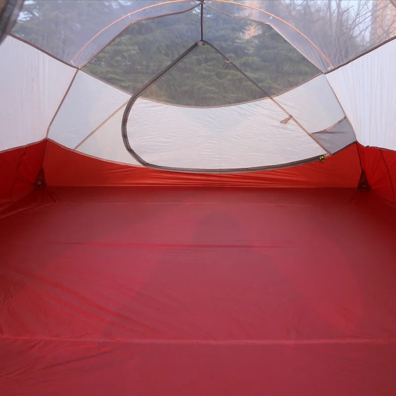 Grey outdoor multi-person tent with aluminum pole and nylon fabric set up on grass