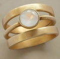 Gold-plated geometric ring with white chalcedony inlay on titanium steel band