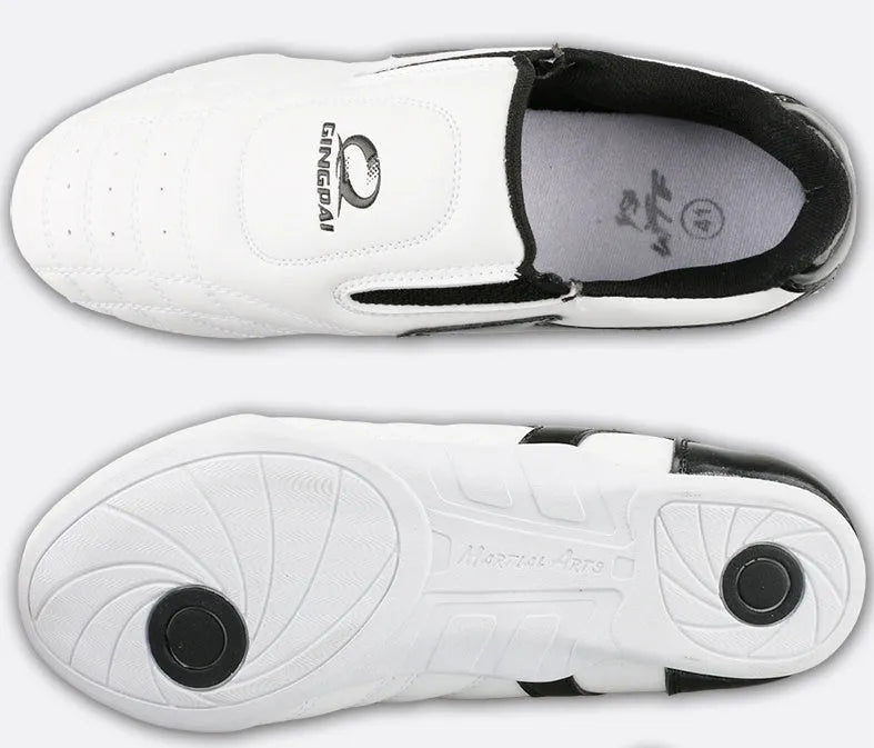 Black and white children's martial arts training shoes with soft bottom construction and widened design