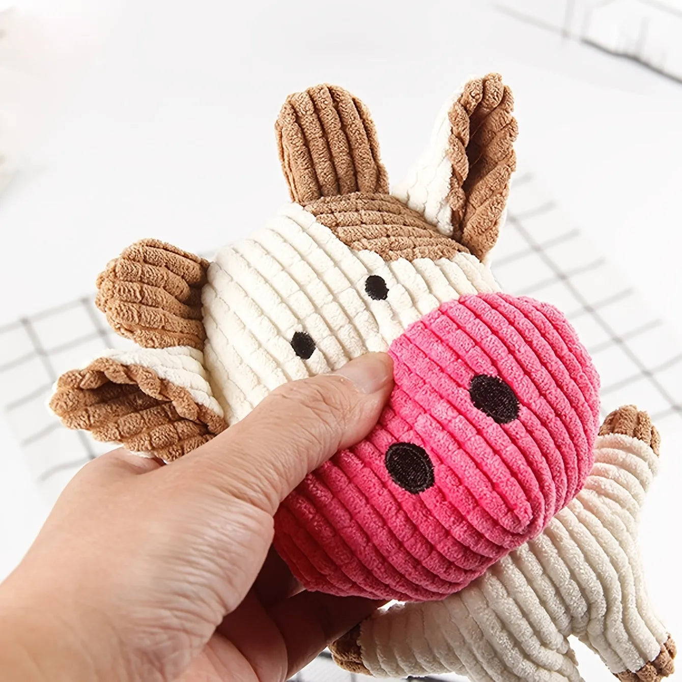 Colourful animal-shaped plush dog chew toy with squeaker for small dogs.