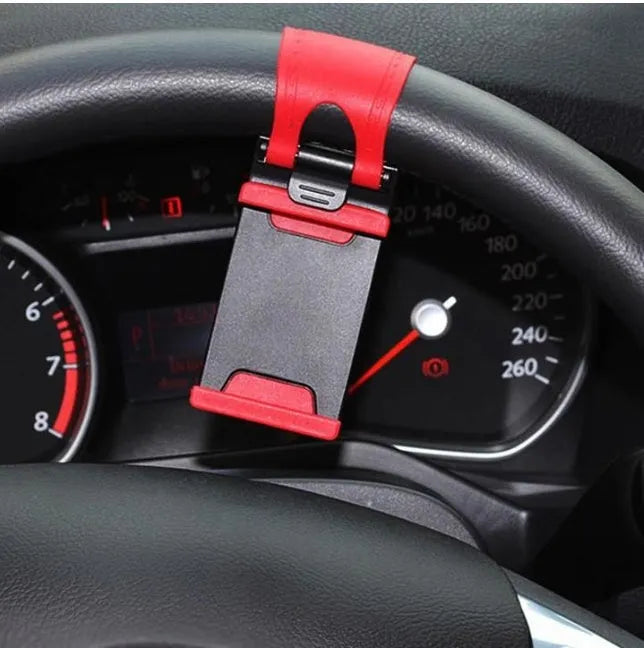Black steering wheel phone holder clip mounted on car steering wheel holding smartphone