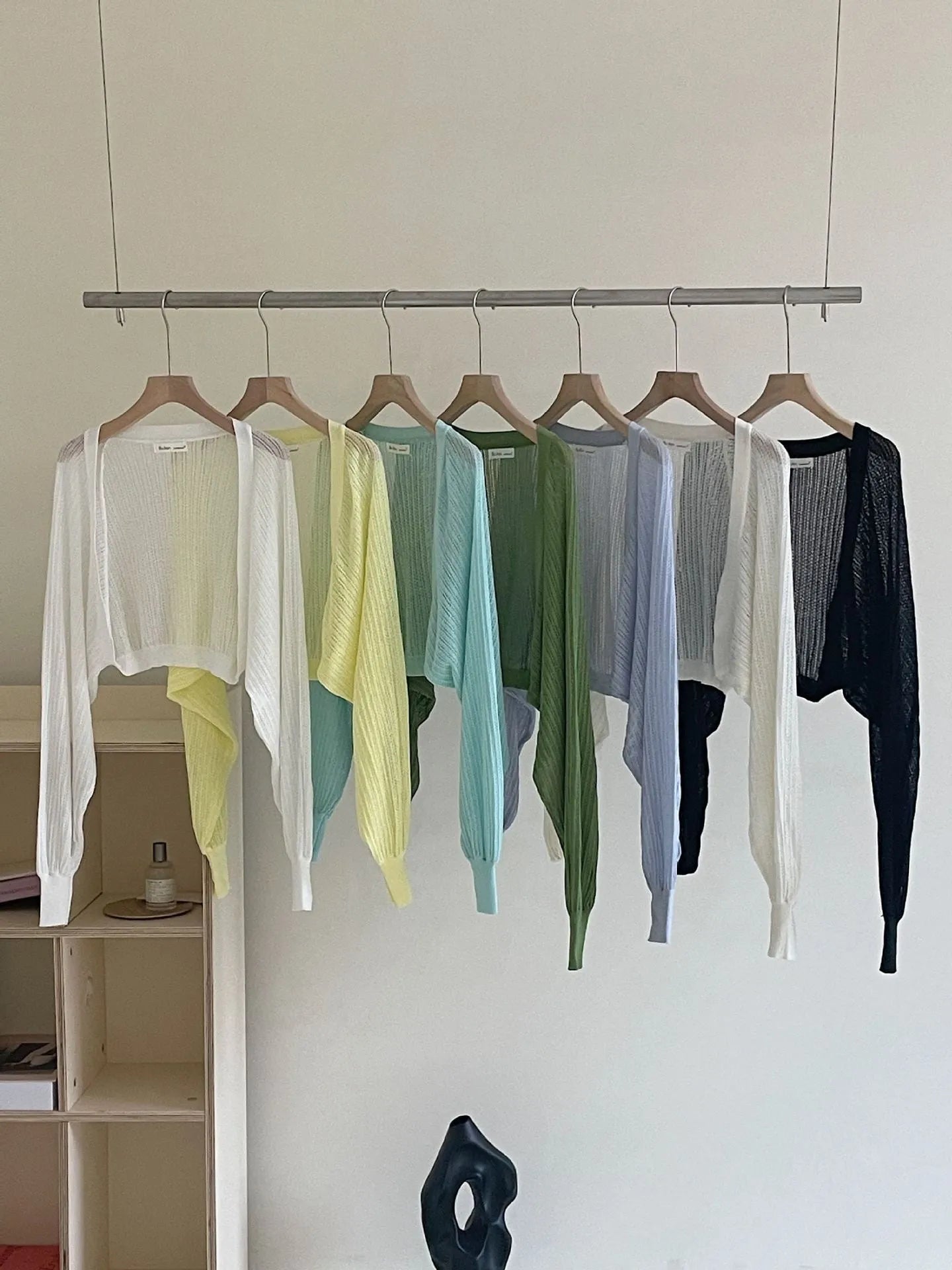 Women's apricot coloured blouse with long loose lantern sleeves and a hollow linen-look weave.