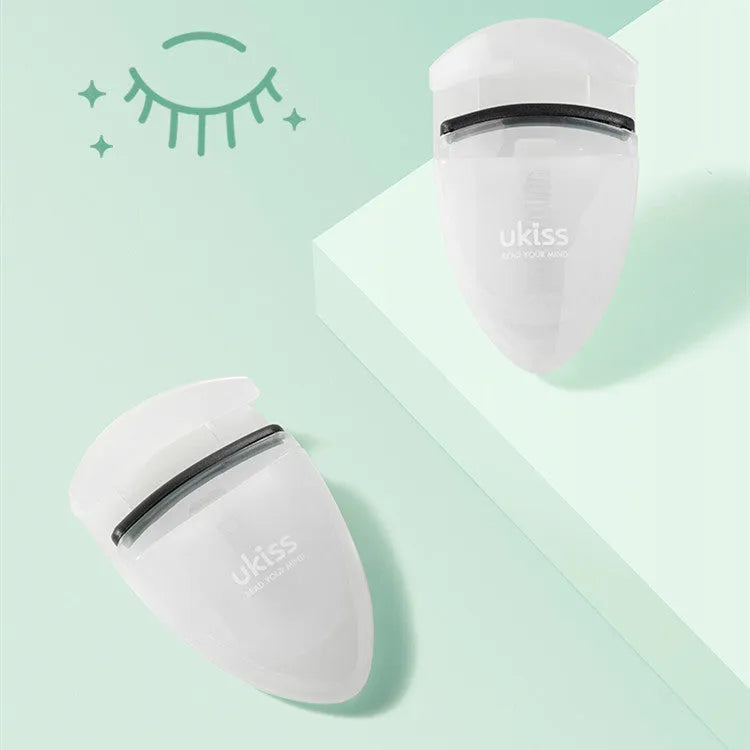 Mini portable eyelash curler in white with silicone pad and stainless steel arm