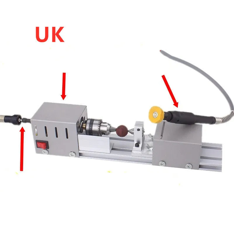 Mini metal manual woodworking lathe with carving knives on a workbench