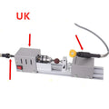 Mini metal manual woodworking lathe with carving knives on a workbench
