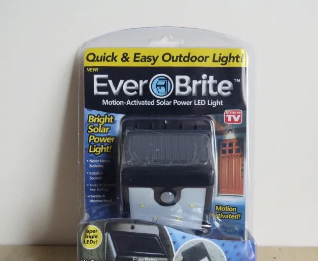 Set of four white solar-powered LED security lights with motion sensors for outdoor wall or post mounting.