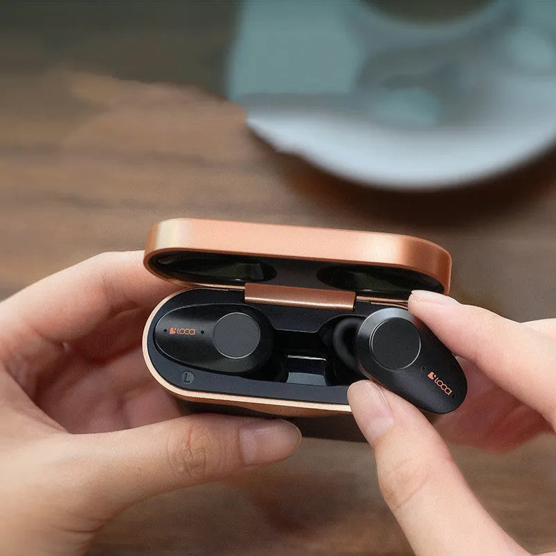 Black wireless Bluetooth earbuds with charging stand featuring ANC and 10m range.