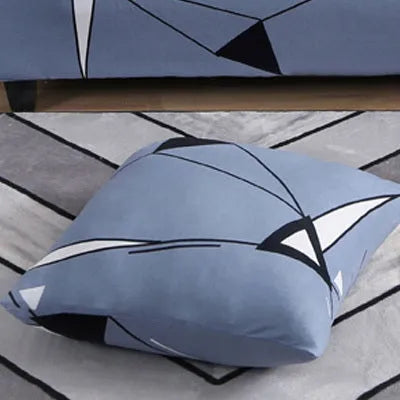 Stretchable geometric print sofa slipcover covering a three-seater sofa with matching pillow