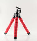 Black flexible octopus tripod wrapped around a pole holding a smartphone