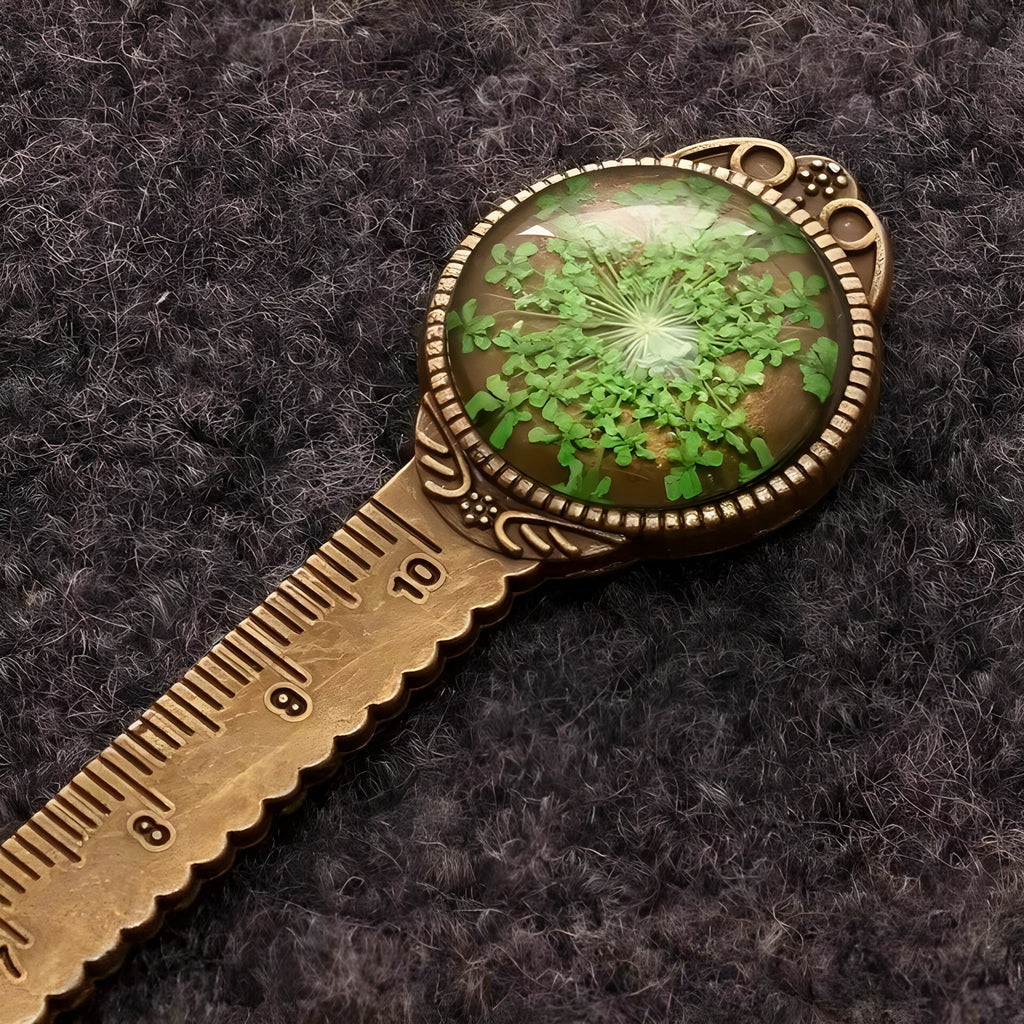 Handmade dried flower bookmark ruler with gypsophila, lace flowers, and clover, 12cm long on a book page.