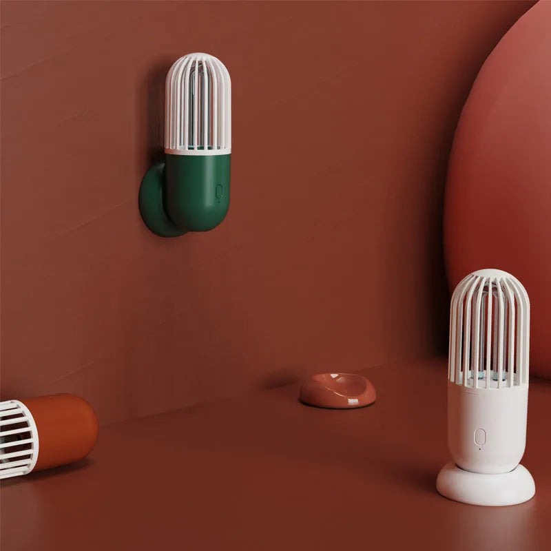 Portable capsule-shaped ultraviolet UVC disinfection lamp in black, showing compact size.