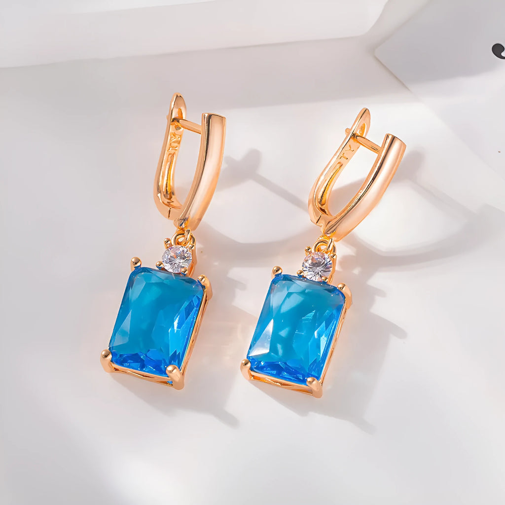 A pair of square gold and silver geometric electroplated earrings with a quadrilateral design.
