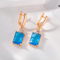 A pair of square gold and silver geometric electroplated earrings with a quadrilateral design.