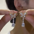 Platinum bow stud earrings with zinc alloy construction and electroplated finish