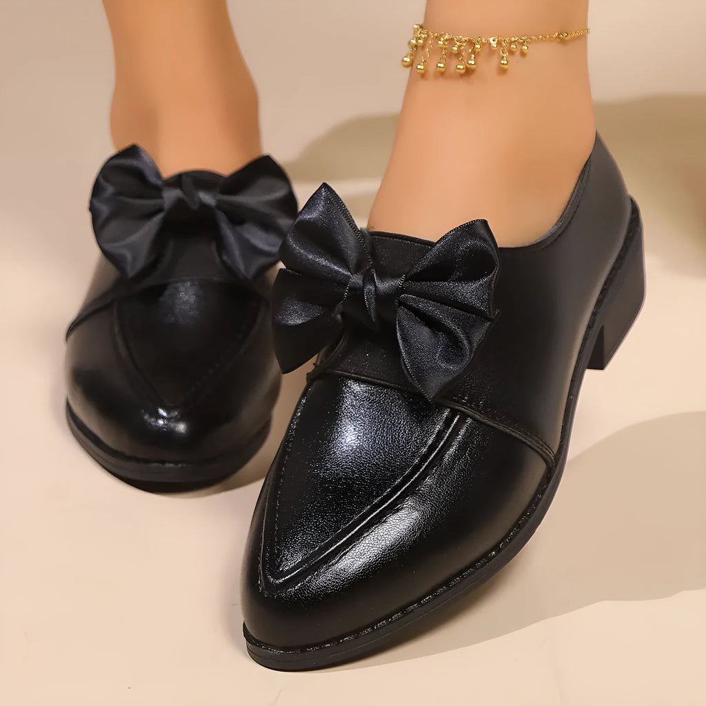 Women's British-style leather-look slip-on shoes with a decorative bow on the front