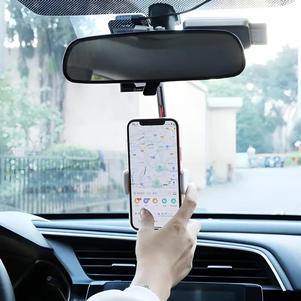 Black ABS plastic mobile phone bracket mounted on car rearview mirror holding smartphone