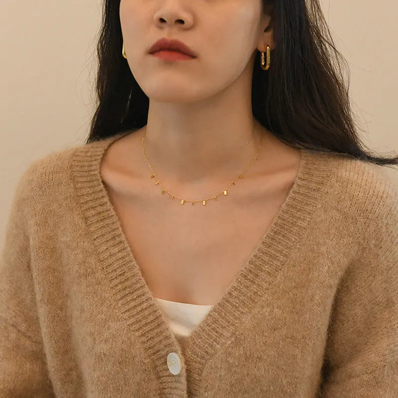 Gold titanium steel necklace with round circle, waterdrop and rectangle charms on a cross chain, adjustable 21-50cm.