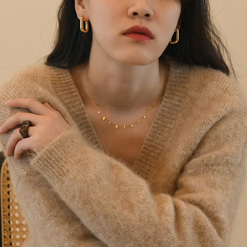 Gold titanium steel necklace with round circle, waterdrop and rectangle charms on a cross chain, adjustable 21-50cm.