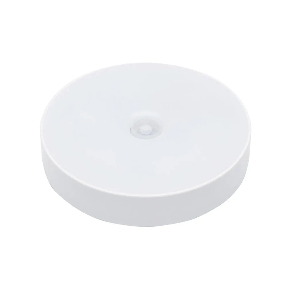 Small round motion sensing LED night light with USB charging port in beige colour