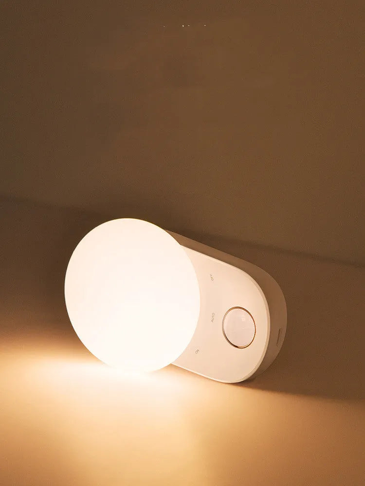 White rechargeable sensor night light with motion detection and USB charging port.