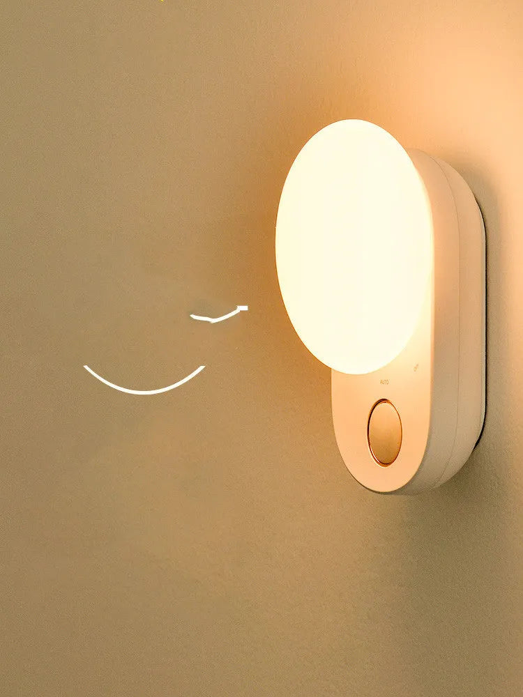 White rechargeable sensor night light with motion detection and USB charging port.