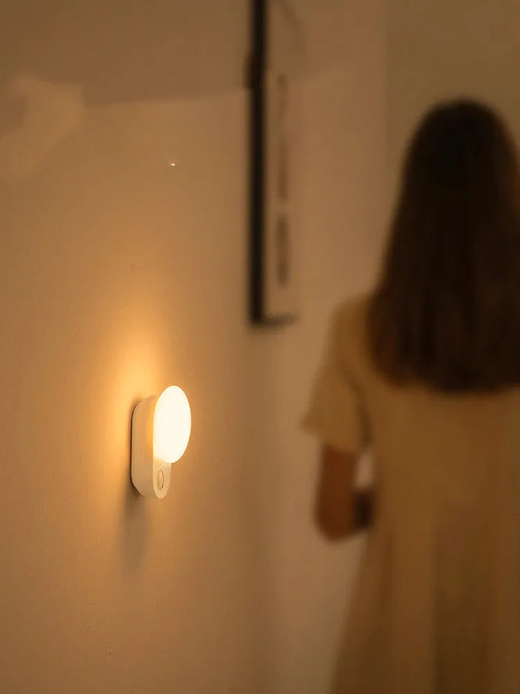 White rechargeable sensor night light with motion detection and USB charging port.