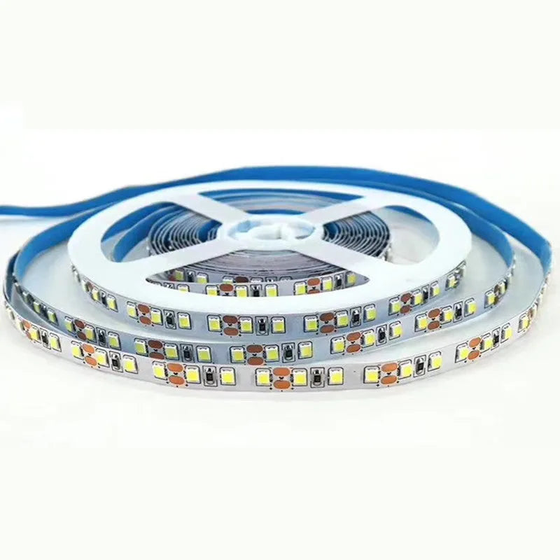 Close-up of a flexible white LED light strip with densely packed LEDs, shown bending around a corner.