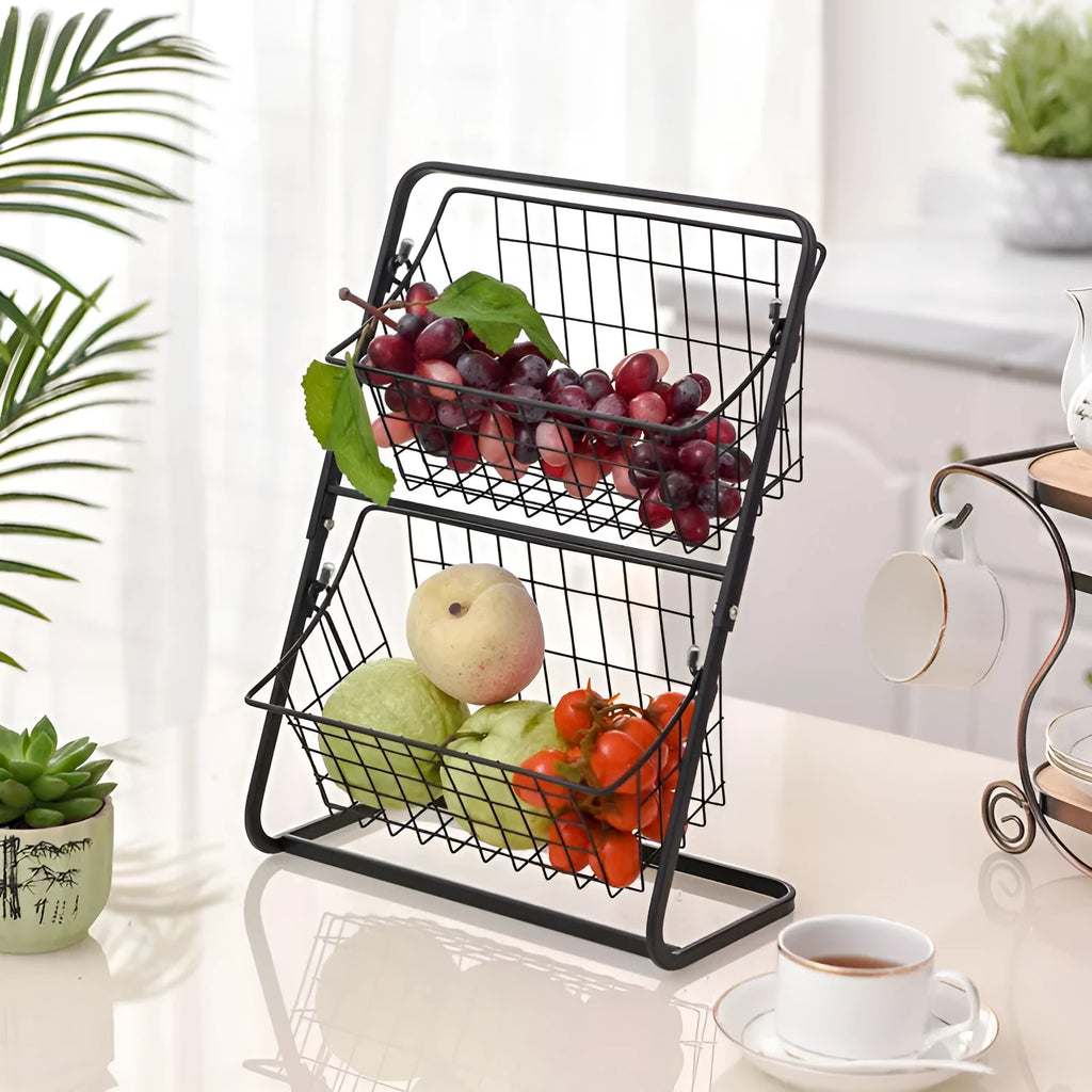 Black two-tier stainless steel kitchen storage rack with fruit and vegetables on countertop