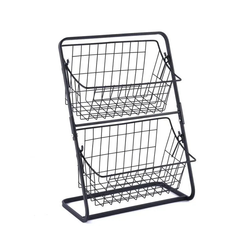 Black two-tier stainless steel kitchen storage rack with fruit and vegetables on countertop
