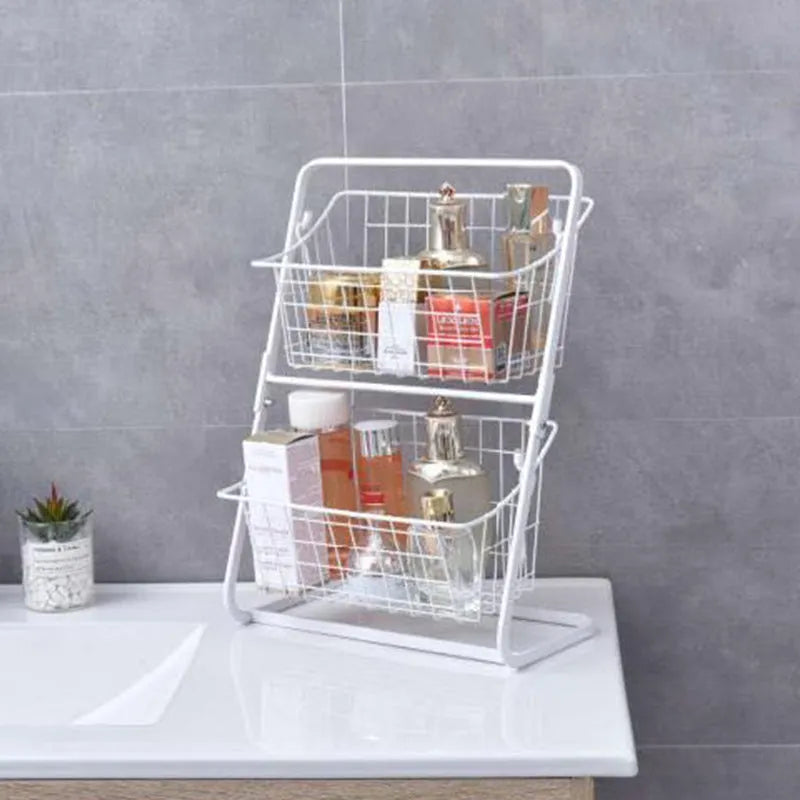 Black two-tier stainless steel kitchen storage rack with fruit and vegetables on countertop