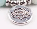 Natural stone powder crystal yoga bracelet with silver Buddha charm lotus pendant on neutral background
