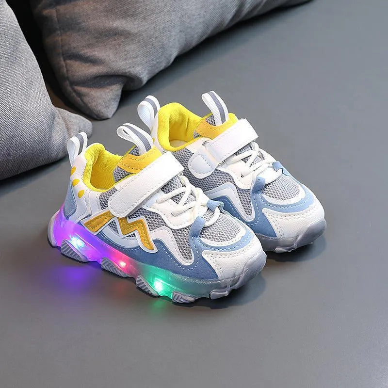 A pair of grey children's velcro sneakers with a breathable mesh upper and rubber sole, shown on a white background.
