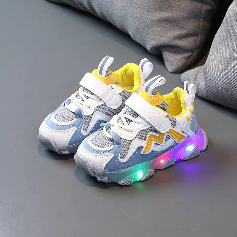 A pair of grey children's velcro sneakers with a breathable mesh upper and rubber sole, shown on a white background.