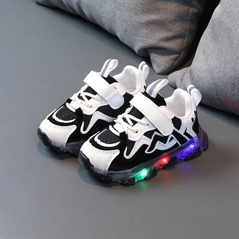 A pair of grey children's velcro sneakers with a breathable mesh upper and rubber sole, shown on a white background.