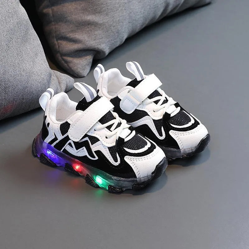 A pair of grey children's velcro sneakers with a breathable mesh upper and rubber sole, shown on a white background.