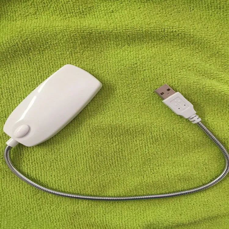 Flexible USB LED reading lamp with clip attached to book