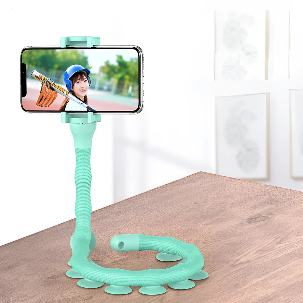 Flexible rubber phone holder with suction cup mounted on a surface showing 360-degree rotation capability