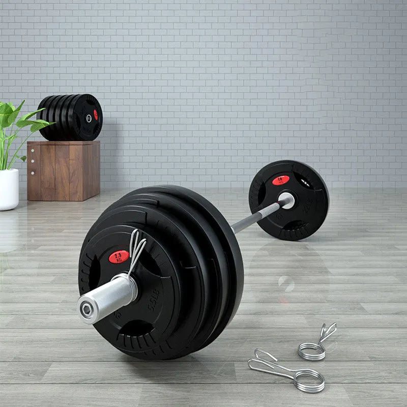 Black rubber covered cast iron barbell weight plates on gym floor