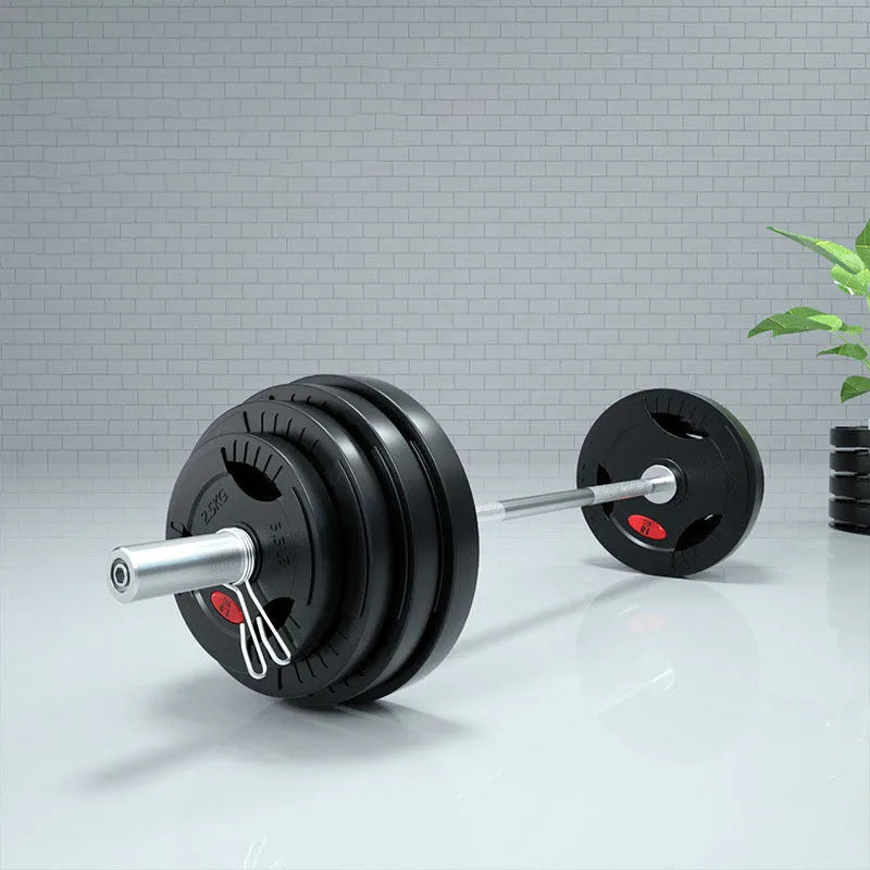 Black rubber covered cast iron barbell weight plates on gym floor