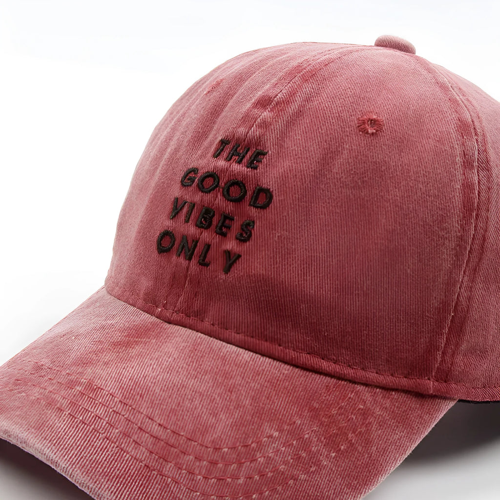 Washed cotton dad hat in bone colour with embroidered THE GOOD VIBES ONLY lettering, adjustable snapback, short curling brim