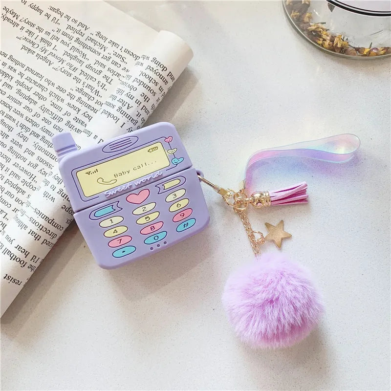 Purple silicone AirPods protective case with clamshell design and attached fur ball pendant