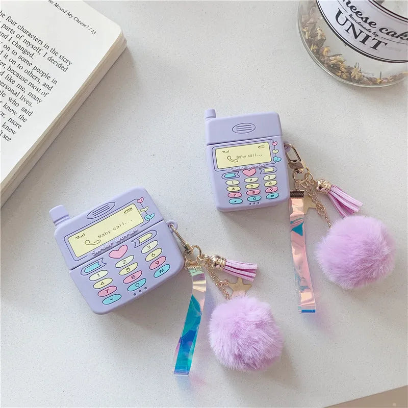 Purple silicone AirPods protective case with clamshell design and attached fur ball pendant
